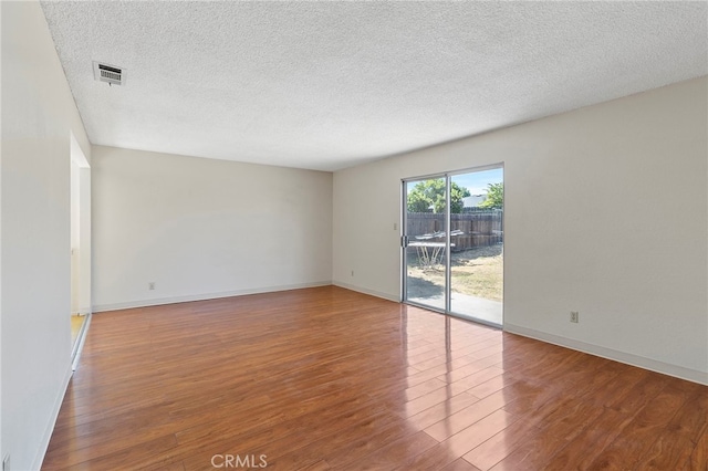 2151 W Pico Ave, Fresno, CA 93705 - unfurnished room with wood finished floors and a textured ceiling