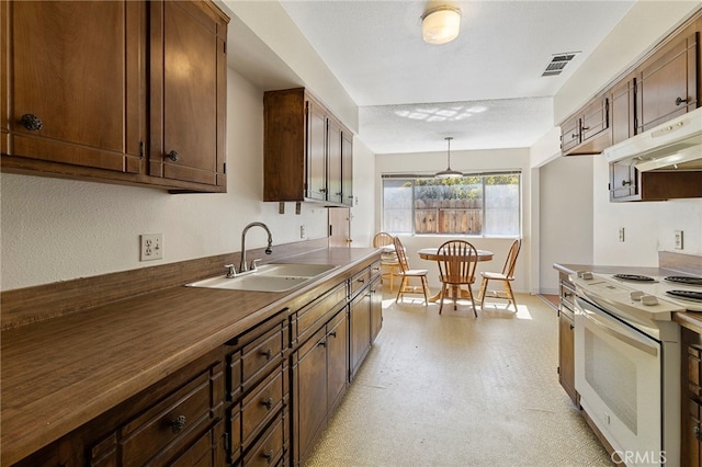 2151 W Pico Ave, Fresno, CA 93705 - kitchen with white range with electric stovetop, under cabinet range hood, pendant lighting, and light floors