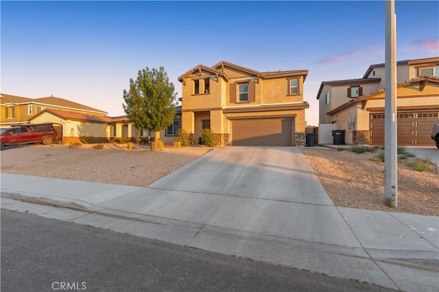 3558 Mt San Gorgonia Ave, Rosamond, CA 93560 - view of front of home with stone siding, concrete driveway, stucco siding, a garage, and a residential view