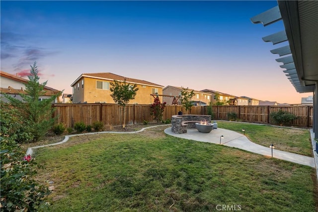 3558 Mt San Gorgonia Ave, Rosamond, CA 93560 - yard at dusk featuring a patio, a fenced backyard, and a fire pit