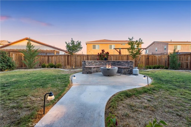 3558 Mt San Gorgonia Ave, Rosamond, CA 93560 - yard at dusk with a patio area, a fenced backyard, and a fire pit