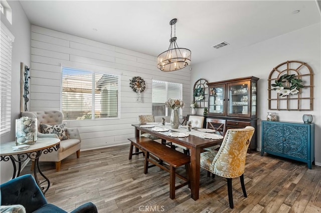 3558 Mt San Gorgonia Ave, Rosamond, CA 93560 - dining space with wood finished floors, wooden walls, and a chandelier