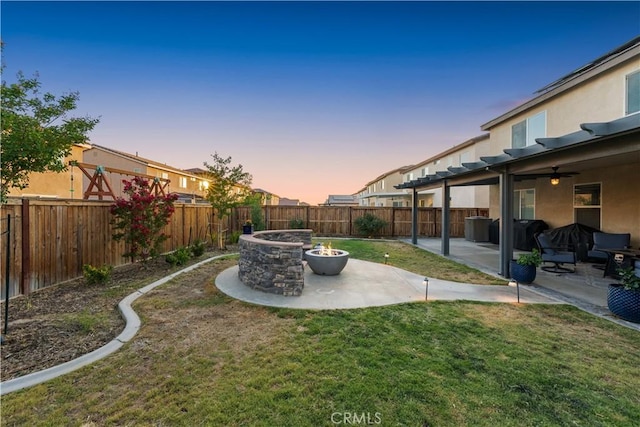 3558 Mt San Gorgonia Ave, Rosamond, CA 93560 - yard at dusk with an outdoor fire pit, a fenced backyard, a patio, and a ceiling fan