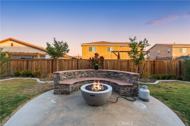 3558 Mt San Gorgonia Ave, Rosamond, CA 93560 - patio terrace at dusk with a fire pit, a patio area, and a fenced backyard