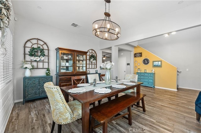 3558 Mt San Gorgonia Ave, Rosamond, CA 93560 - dining area with a chandelier, wood finished floors, and ceiling fan