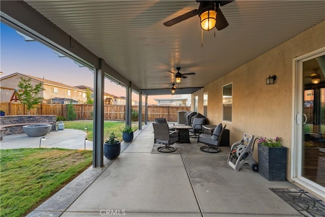 3558 Mt San Gorgonia Ave, Rosamond, CA 93560 - fenced backyard with a patio, a ceiling fan, and an outdoor living space with a fire pit