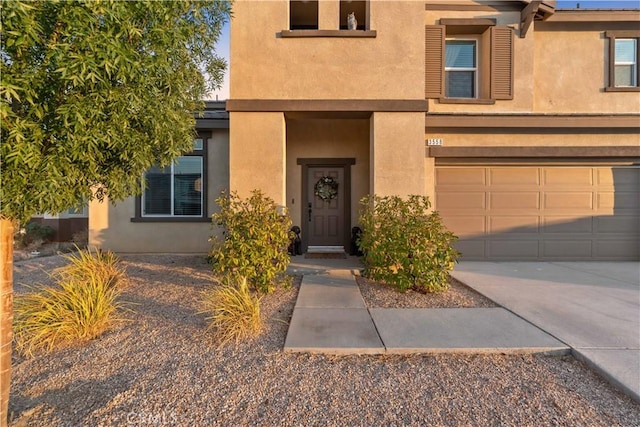 3558 Mt San Gorgonia Ave, Rosamond, CA 93560 - view of front of property with stucco siding, driveway, and an attached garage