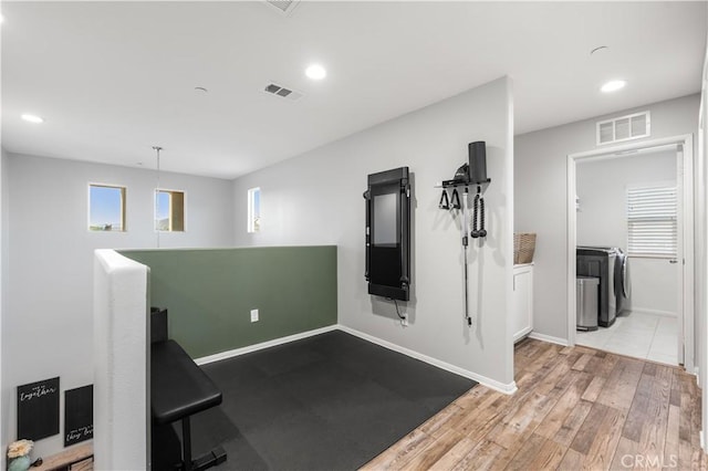 3558 Mt San Gorgonia Ave, Rosamond, CA 93560 - exercise room featuring separate washer and dryer, recessed lighting, and wood finished floors