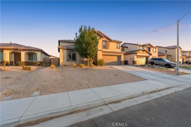 3558 Mt San Gorgonia Ave, Rosamond, CA 93560 - view of front facade with concrete driveway, stucco siding, an attached garage, and a residential view