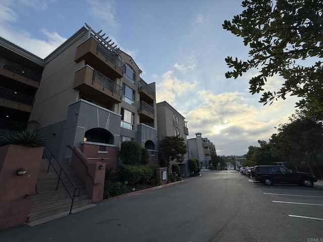 3887 Pell Pl Unit 134, San Diego, CA 92130 - view of building exterior featuring uncovered parking and stairway