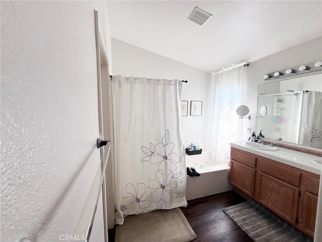 28303 Sycamore Dr, Saugus, CA 91350 - full bathroom with a garden tub, wood finished floors, curtained shower, double vanity, and lofted ceiling