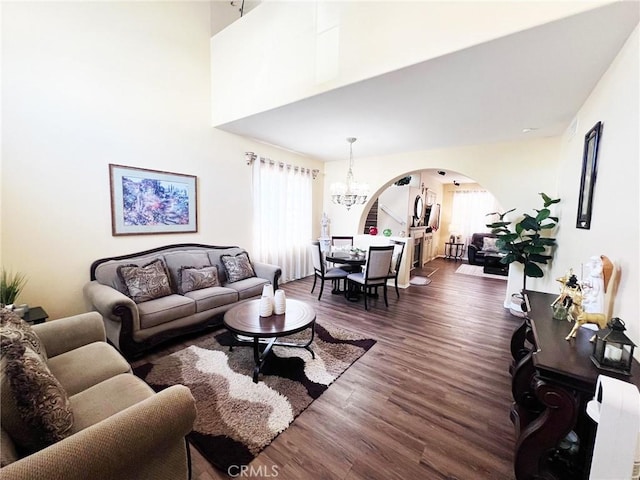 28303 Sycamore Dr, Saugus, CA 91350 - living area featuring arched walkways, wood finished floors, and a chandelier