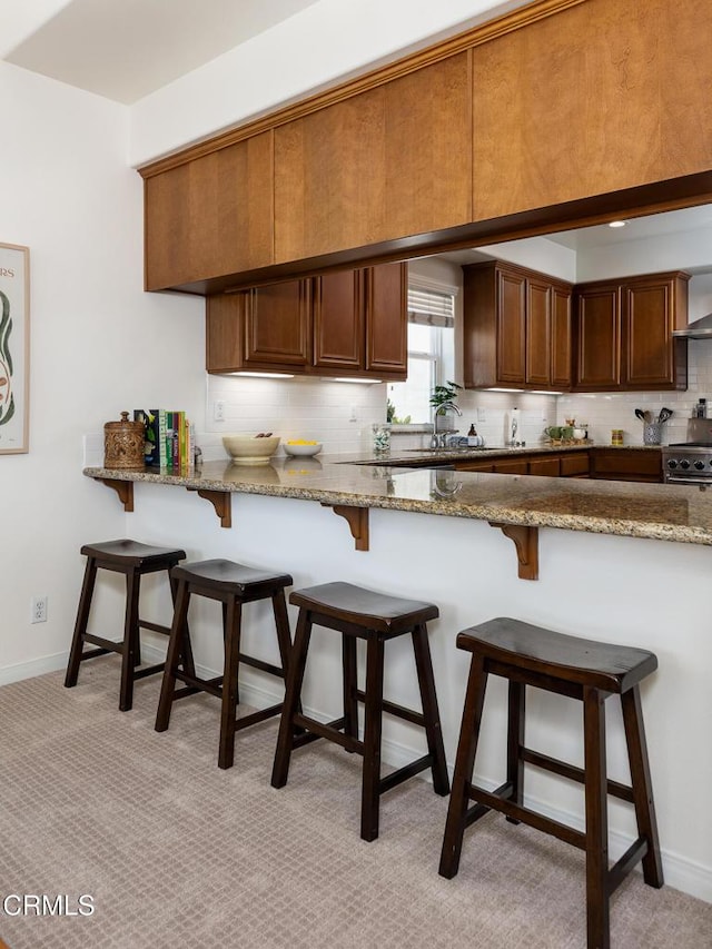 274 S Prospect Ave, Tustin, CA 92780 - kitchen featuring backsplash, high end range, a breakfast bar, and stone countertops