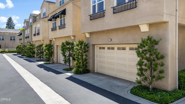 274 S Prospect Ave, Tustin, CA 92780 - view of building exterior with a garage, a residential view, and concrete driveway