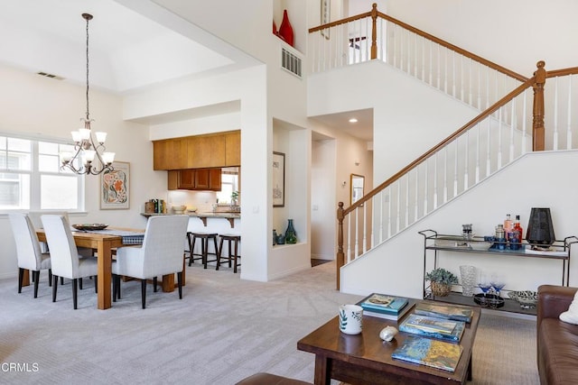 274 S Prospect Ave, Tustin, CA 92780 - dining room featuring stairway, light carpet, a chandelier, and a towering ceiling