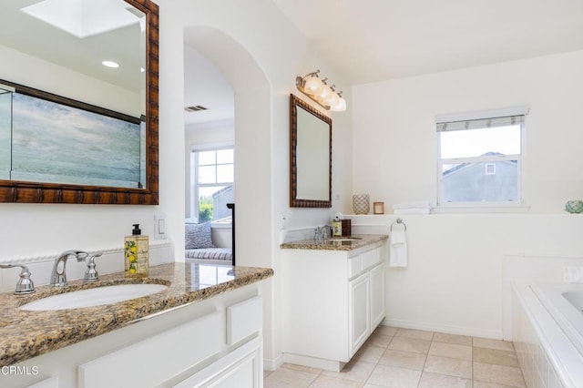 274 S Prospect Ave, Tustin, CA 92780 - bathroom with two vanities, a relaxing tiled tub, and tile patterned flooring