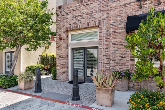 274 S Prospect Ave, Tustin, CA 92780 - doorway to property featuring brick siding, a patio area, and stucco siding