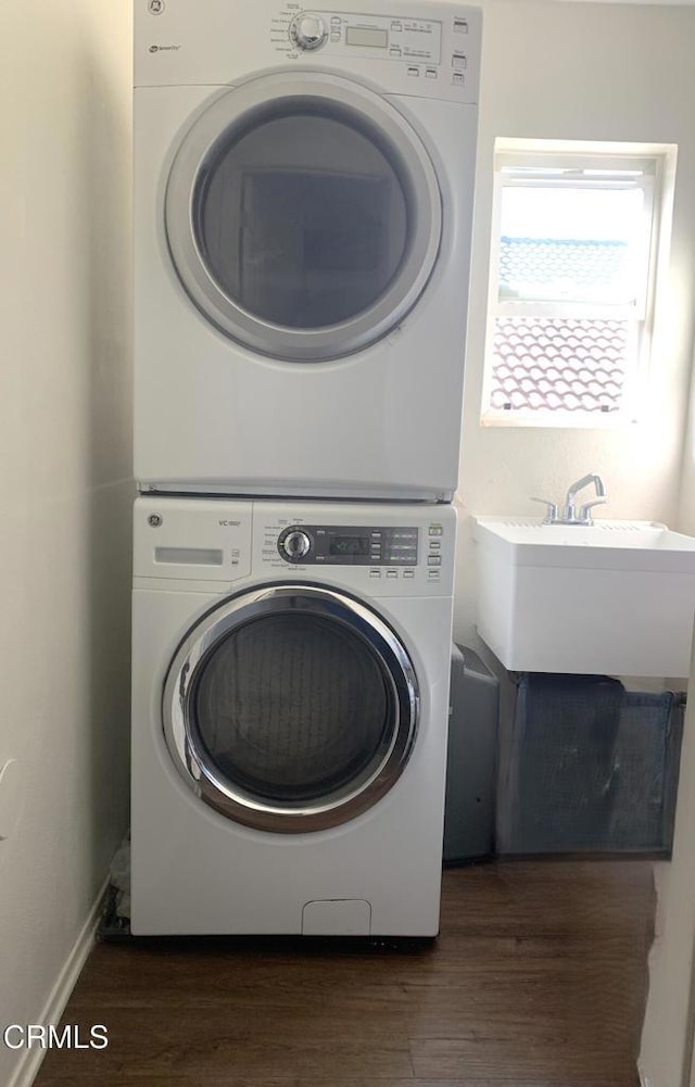 1123 Paseo Las Nubes, Oxnard, CA 93030 - laundry area featuring stacked washer and clothes dryer and dark wood-style flooring