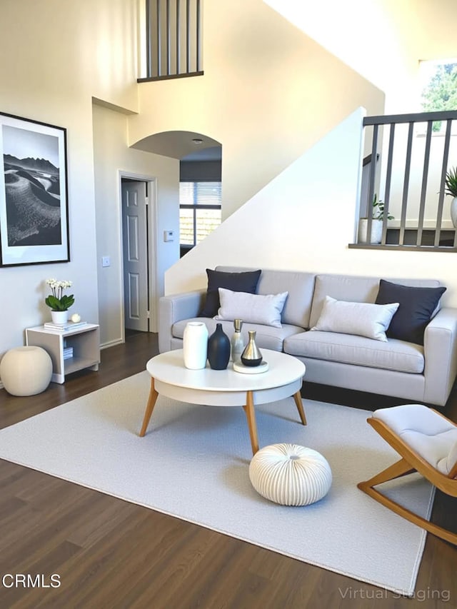 1123 Paseo Las Nubes, Oxnard, CA 93030 - living room with a high ceiling, dark wood-type flooring, and arched walkways