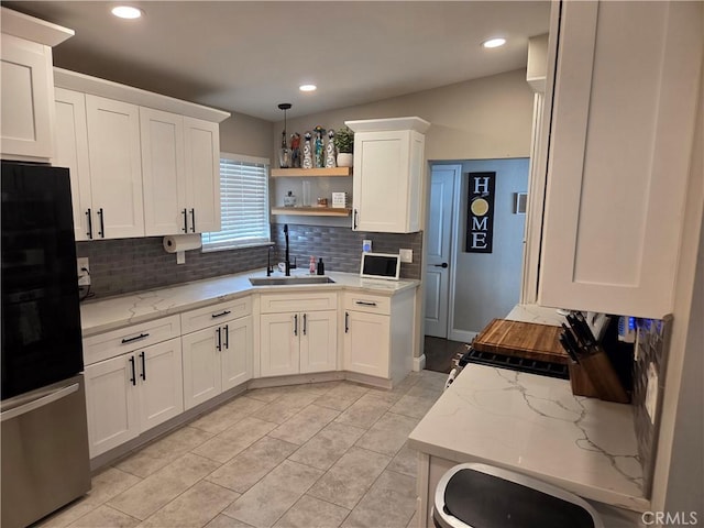 1292 N California Ave, Beaumont, CA 92223 - kitchen with freestanding refrigerator, tasteful backsplash, white cabinetry, light stone counters, and open shelves