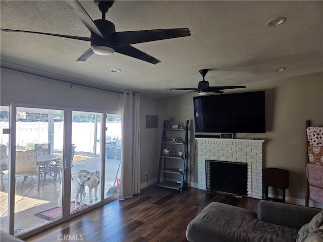 1292 N California Ave, Beaumont, CA 92223 - living area featuring ceiling fan, a textured ceiling, dark wood-type flooring, recessed lighting, and a fireplace