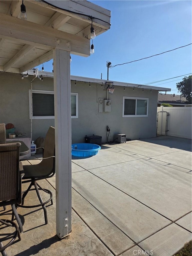 1292 N California Ave, Beaumont, CA 92223 - rear view of property with stucco siding, a patio, and an outdoor pool