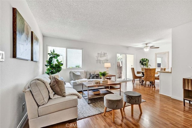 17574 Vandenberg Ln Unit 1, Tustin, CA 92780 - living room featuring a textured ceiling, plenty of natural light, wood finished floors, and ceiling fan