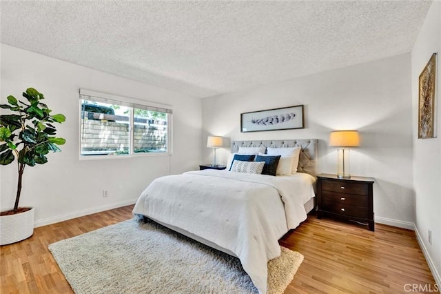 17574 Vandenberg Ln Unit 1, Tustin, CA 92780 - bedroom featuring light wood-style flooring and a textured ceiling