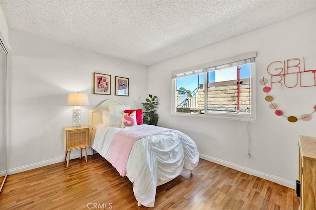 17574 Vandenberg Ln Unit 1, Tustin, CA 92780 - bedroom with a textured ceiling and wood finished floors