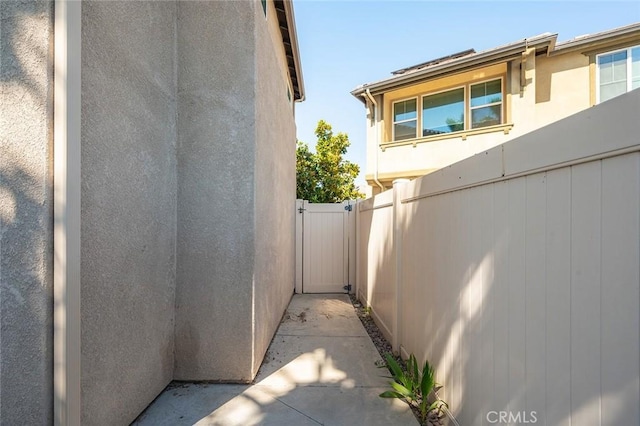 28419 Sunflower St, Highland, CA 92346 - view of property exterior with stucco siding and a gate