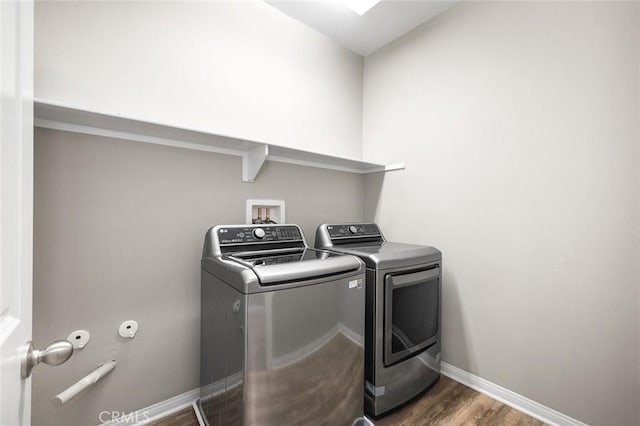 28419 Sunflower St, Highland, CA 92346 - laundry area with washing machine and dryer and dark wood-style flooring