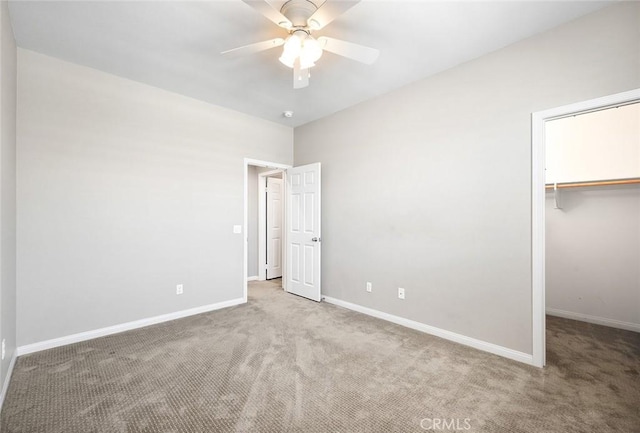 28419 Sunflower St, Highland, CA 92346 - unfurnished bedroom featuring carpet flooring, a walk in closet, and a ceiling fan