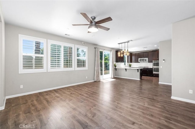 28419 Sunflower St, Highland, CA 92346 - unfurnished living room with ceiling fan, dark wood finished floors, and a chandelier