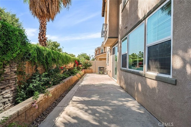 28419 Sunflower St, Highland, CA 92346 - view of home's exterior with stucco siding, a fenced backyard, and a patio area