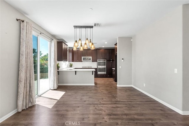 28419 Sunflower St, Highland, CA 92346 - kitchen with a chandelier, dark brown cabinets, dark wood-style flooring, a peninsula, and stainless steel appliances