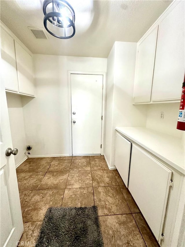 3415 Genoa Pl, Palmdale, CA 93551 - laundry room featuring cabinet space and tile patterned flooring