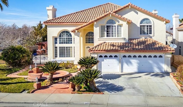 3415 Genoa Pl, Palmdale, CA 93551 - mediterranean / spanish home featuring a chimney, concrete driveway, a garage, and a tile roof