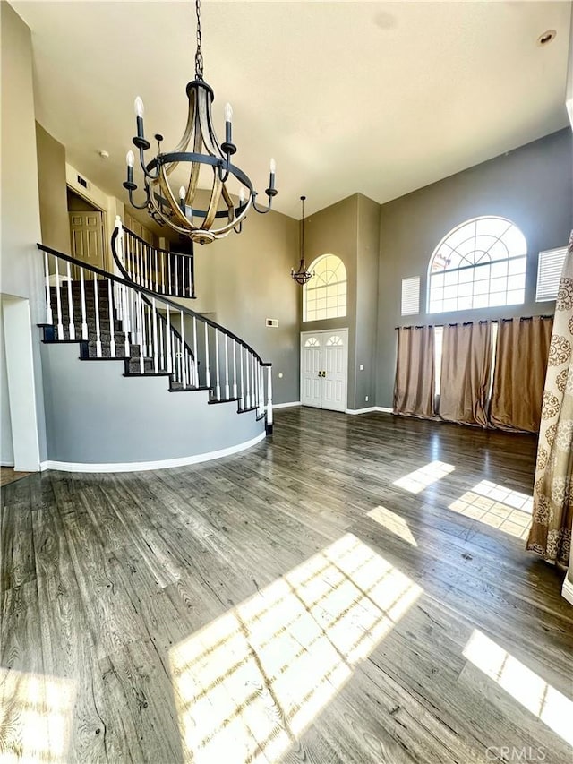3415 Genoa Pl, Palmdale, CA 93551 - unfurnished living room with a chandelier, wood finished floors, and stairs