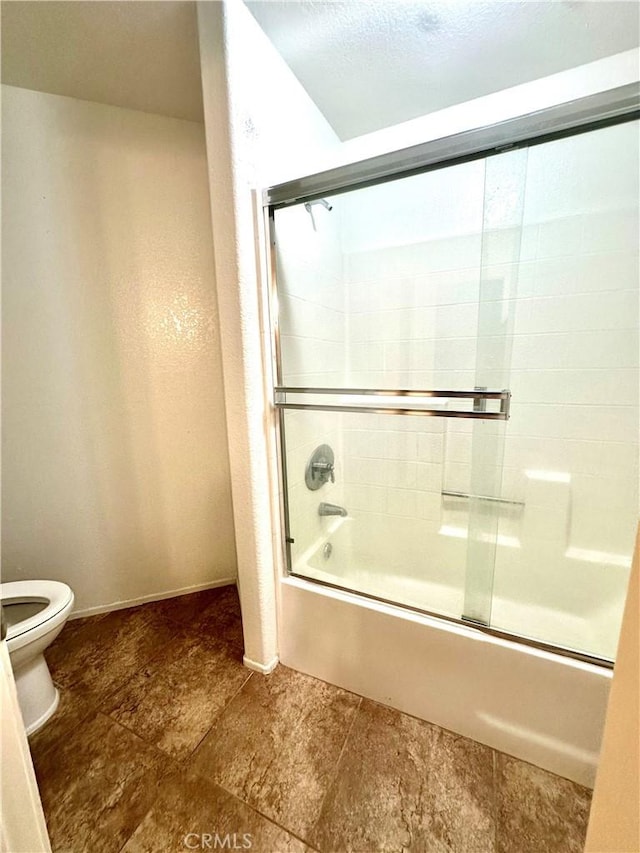 3415 Genoa Pl, Palmdale, CA 93551 - full bathroom featuring toilet and bath / shower combo with glass door