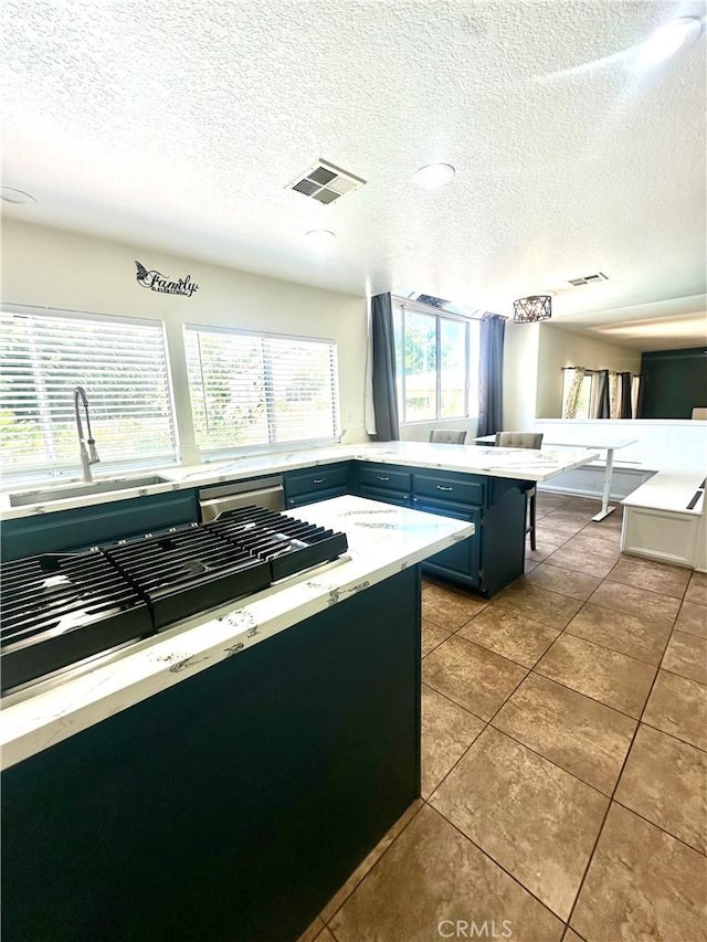 3415 Genoa Pl, Palmdale, CA 93551 - kitchen with a textured ceiling, tile patterned floors, blue cabinetry, and light stone countertops
