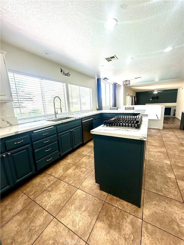 3415 Genoa Pl, Palmdale, CA 93551 - kitchen with stainless steel gas cooktop, light countertops, a textured ceiling, dishwashing machine, and light tile patterned floors