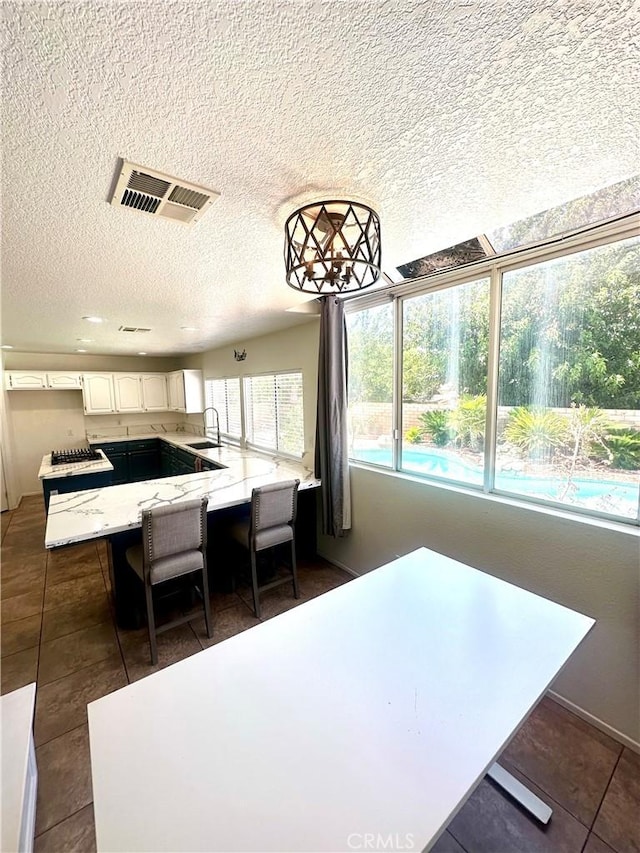 3415 Genoa Pl, Palmdale, CA 93551 - dining space with dark tile patterned floors and a textured ceiling