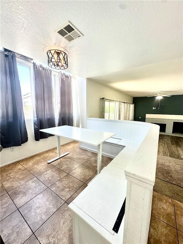 3415 Genoa Pl, Palmdale, CA 93551 - kitchen featuring a textured ceiling, light countertops, tile patterned flooring, a ceiling fan, and open floor plan