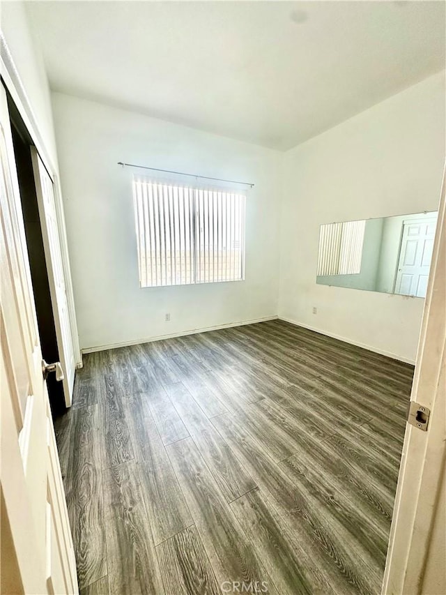 3415 Genoa Pl, Palmdale, CA 93551 - unfurnished bedroom with dark wood finished floors and a closet