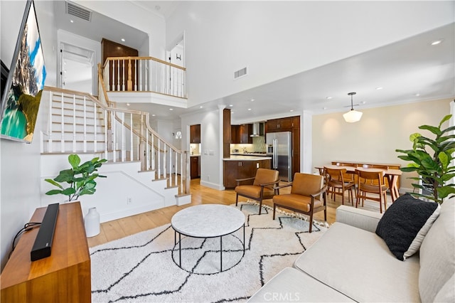 29426 Via Napoli Unit 121, Laguna Niguel, CA 92677 - living room with light wood-style floors, stairs, crown molding, and recessed lighting