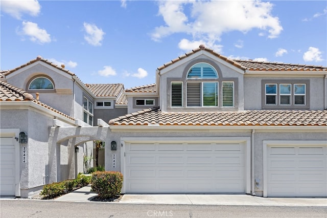 29426 Via Napoli Unit 121, Laguna Niguel, CA 92677 - mediterranean / spanish house with a tile roof, stucco siding, concrete driveway, and an attached garage