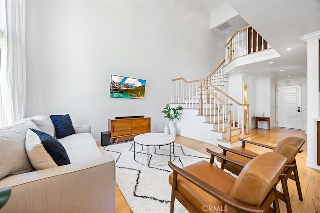29426 Via Napoli Unit 121, Laguna Niguel, CA 92677 - living area with light wood-type flooring, crown molding, a towering ceiling, stairway, and recessed lighting