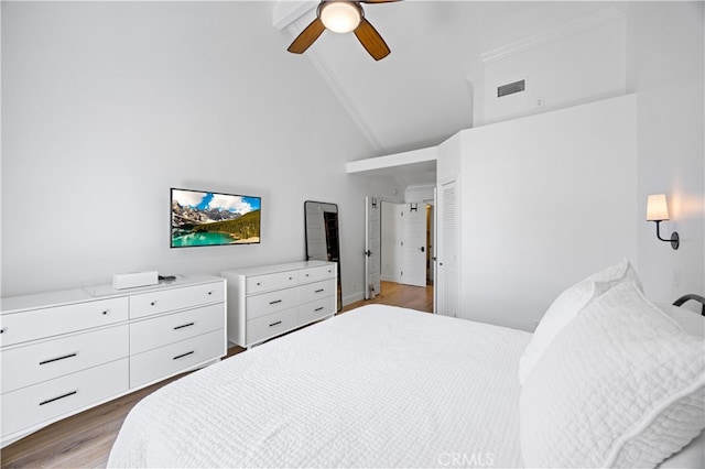 29426 Via Napoli Unit 121, Laguna Niguel, CA 92677 - bedroom with high vaulted ceiling, wood finished floors, a ceiling fan, and beamed ceiling