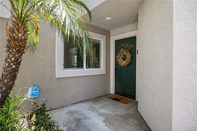 29426 Via Napoli Unit 121, Laguna Niguel, CA 92677 - doorway to property featuring stucco siding