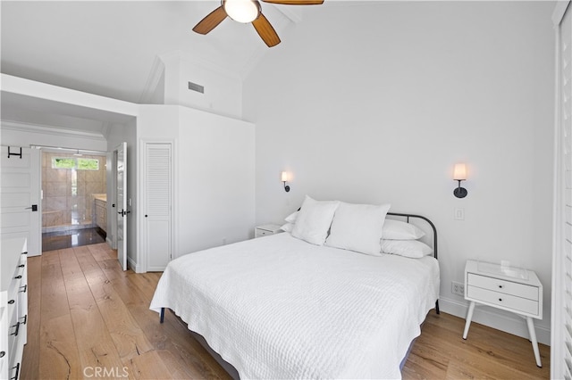 29426 Via Napoli Unit 121, Laguna Niguel, CA 92677 - bedroom with light wood-type flooring, a ceiling fan, ensuite bath, and high vaulted ceiling